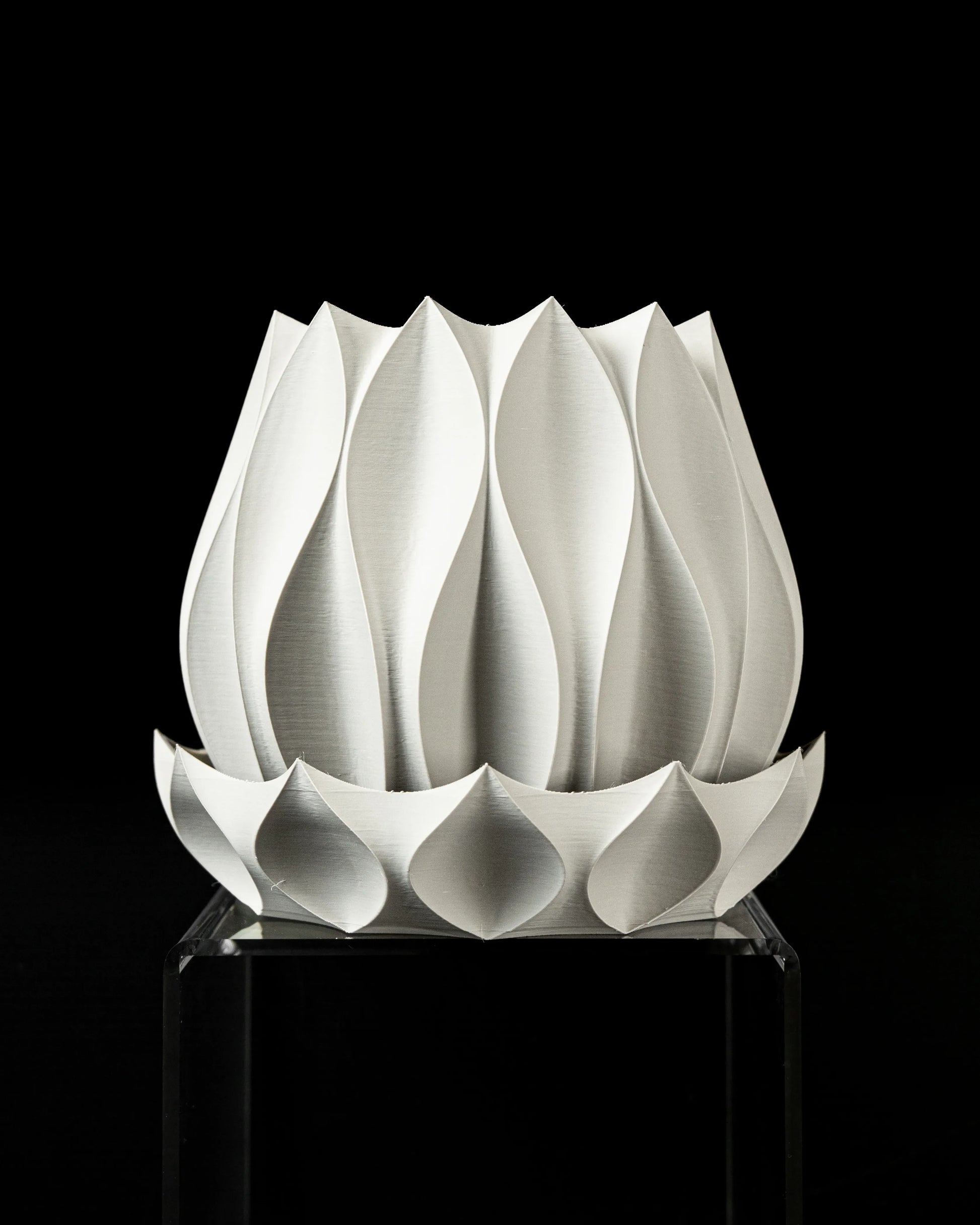 Pot décoratif blanc en matériau durable avec un design contemporain aux formes sculpturales évoquant des pétales entrelacés.