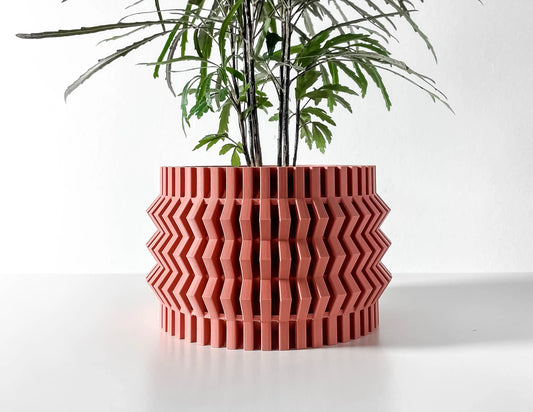Pot décoratif Alio rouge en matériau durable au design contemporain avec motifs géométriques en relief.