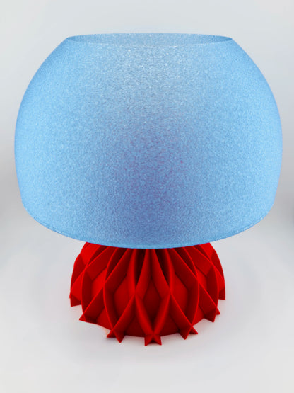 Lampe Arkan design contemporain avec abat-jour bleu translucide lisse et base rouge texturée en plastique durable.