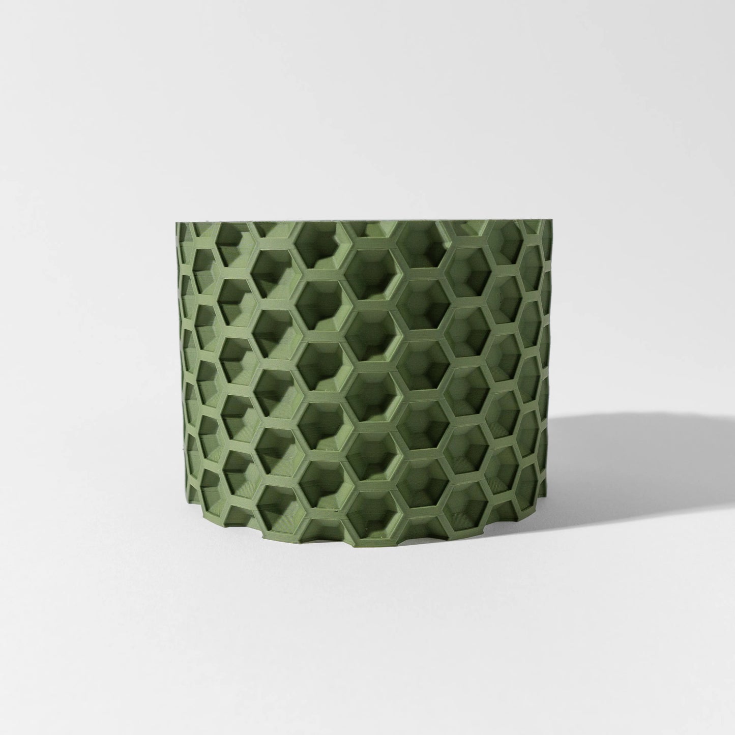 Pot décoratif vert forêt en matériau durable avec motif hexagonal en relief, design contemporain.
