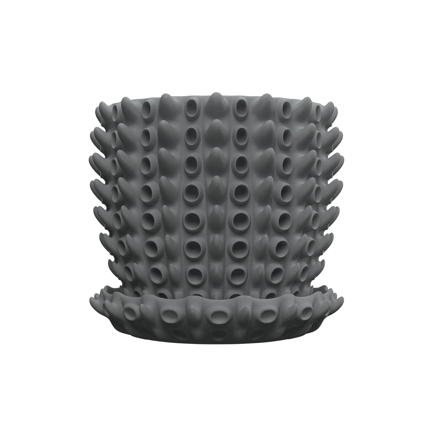 Pot décoratif gris foncé en silicone, surface texturée avec motifs circulaires en relief alignés verticalement, forme.