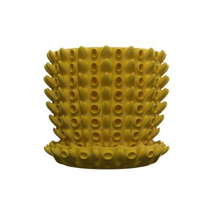 Pot décoratif rond jaune moutarde avec texture tridimensionnelle de tubercules cylindriques sur toute la surface, posé sur.