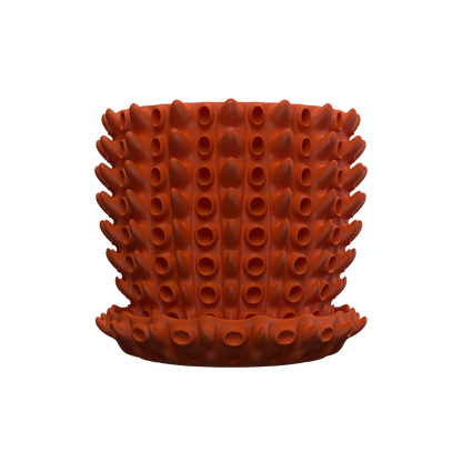 Pot décoratif orange vif en forme cylindrique, surface texturée avec motifs tubulaires en relief, style moderne et unique.