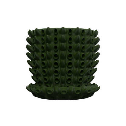 Pot décoratif vert foncé en plastique avec texture en forme de tubes creux disposés en spirale.