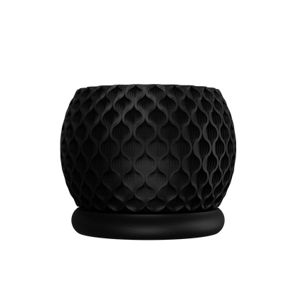 Pot décoratif noir mat avec texture alvéolée en relief, forme arrondie avec base ronde plate.