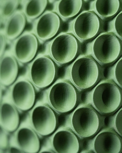 Pot décoratif vert olive à surface texturée avec motifs de bulles arrondies en relief, finition mate et moderne.