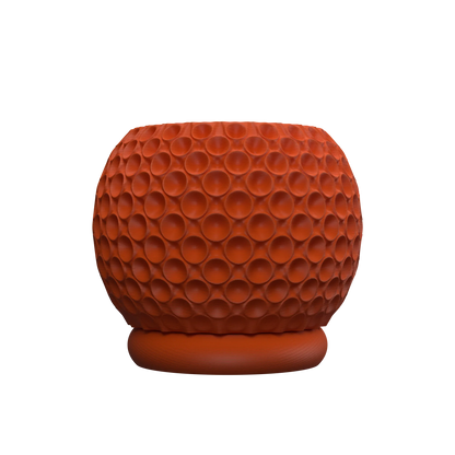 Pot décoratif rond en terre cuite rouge, surface texturée avec motifs de bulles creusées, base légèrement arrondie.