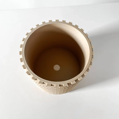 Pot décoratif rond beige avec bordure crantée et surface texturée en relief, style moderne industriel.