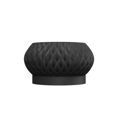 Pot décoratif noir mat avec surface texturée en motif géométrique tridimensionnel et base cylindrique lisse.