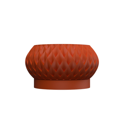 Pot décoratif rond couleur terracotta avec surface sculptée en motifs géométriques en relief sur pied plat uniforme.