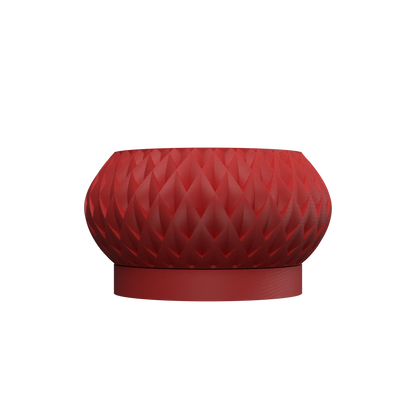 Pot décoratif rouge vif avec texture géométrique en relief, forme ronde et base plate lisse.