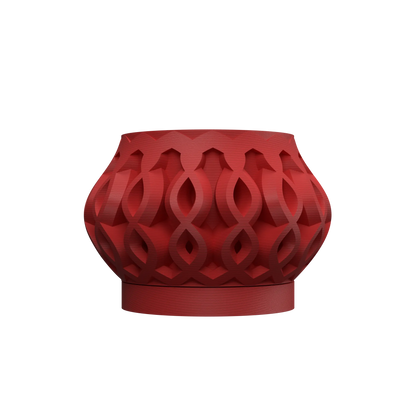 Pot décoratif rouge intense avec surface sculptée en motifs entrelacés et forme arrondie au col évasé.