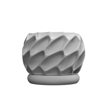 Pot décoratif gris clair mat avec texture géométrique en relief et socle rond assorti.