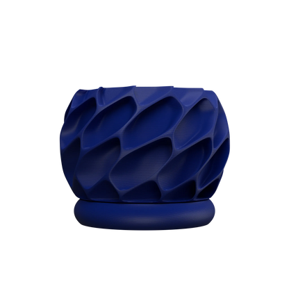 Pot décoratif bleu foncé en matériaux modernes avec motif texturé en relief et base ronde assortie.