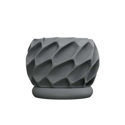 Pot décoratif gris mat avec surface texturée en relief ondulé, forme arrondie et base plate concentrique.