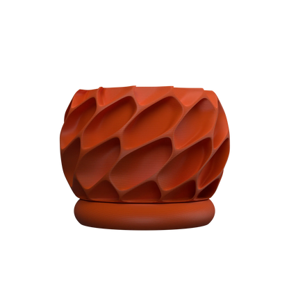 Pot décoratif rond en plastique orange avec surface texturée en motifs tridimensionnels incurvés et soucoupe assortie.