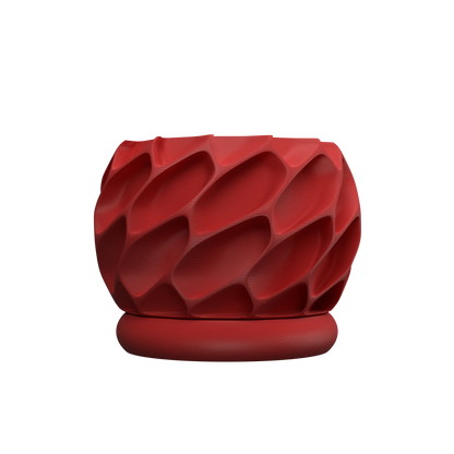 Pot décoratif rouge vif avec surface sculptée en relief ondulé et base ronde assortie.