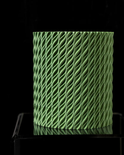 Pot décoratif vert clair cylindrique avec surface texturée en motif torsadé, effet 3D moderne.