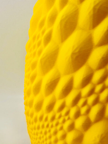 Vase design contemporain jaune texturé en plastique durable avec surface alvéolée sculpturale.