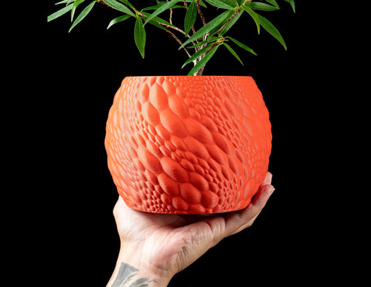 Pot décoratif orange en matériau durable avec texture organique sculptée, design contemporain naturel.