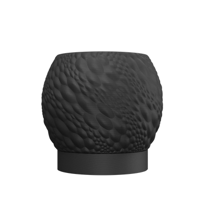 Pot décoratif noir mat au design texturé en relief imitant des motifs organiques, forme arrondie avec base plate légèrement.