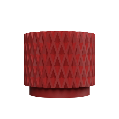Pot décoratif cylindrique rouge avec motif géométrique en relief, base légèrement évasée, style moderne et texturé.