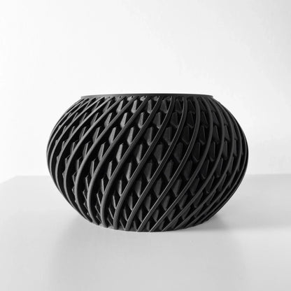 Pot décoratif noir mat en forme arrondie avec motif en treillis incurvé ajouré, style moderne.