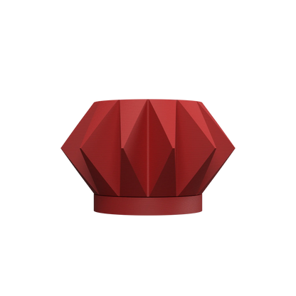 Pot décoratif rouge brique en forme géométrique facettée avec base ronde et design moderne.