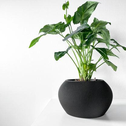 Pot décoratif noir anthracite en matériau durable avec surface striée et design contemporain arrondi.