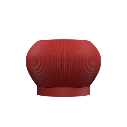 Pot décoratif rond en rouge profond avec surface texturée et base légèrement surélevée, style moderne.