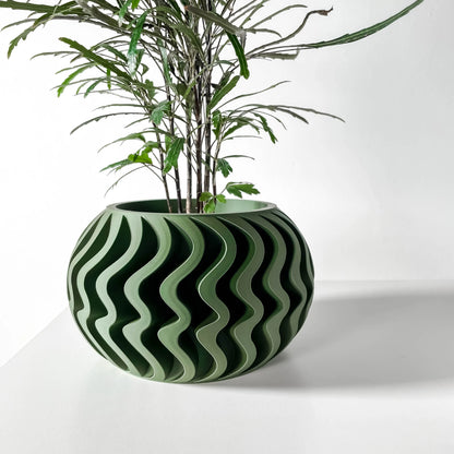 Pot décoratif vert forêt à ondulations en relief, forme ronde avec design contemporain durable.