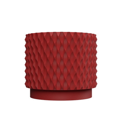Pot décoratif rouge en matériau durable avec design contemporain à motifs géométriques en relief.