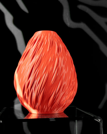 Vase orange vif avec texture nervurée en relief, forme ovale arrondie, finition lisse brillante, style moderne et étanche.